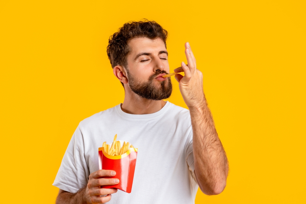 Junk,Food.,Portrait,Of,Hungry,Man,Eating,Tasty,French,Fries