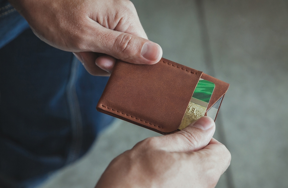 A,Man,Takes,Out,A,Credit,Card,From,A,Cardholder